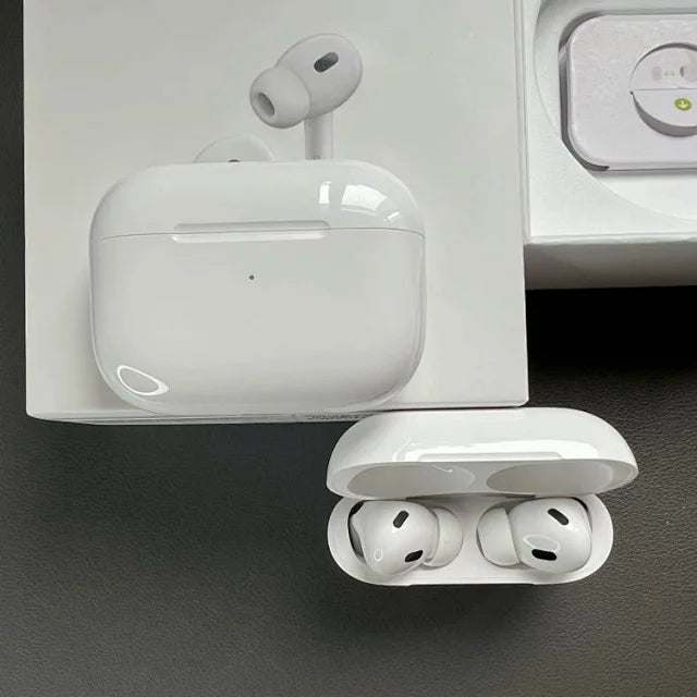 White Apple AirPods Pro with glossy charging case displayed open on dark surface, showing earbuds with silicone tips and