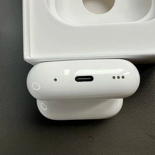 White wireless earbuds with USB-C charging case, showing the case's top with a circular opening and the individual earbud