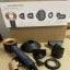 Black audio cables and connectors arranged on white surface with small circular component icons displayed above