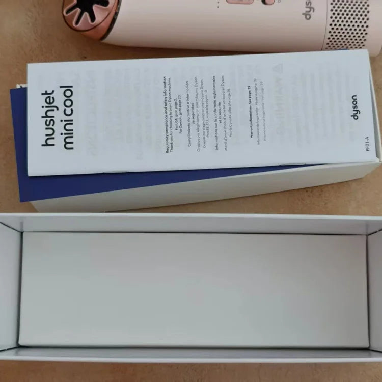 Dyson Hushjet Mini Cool air purifier box with instruction manual displayed, showing white packaging with blue spine and the