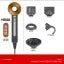 Flat lay of brass and metal hardware tools and components including wrenches, bolts, screws, and fasteners arranged on white