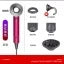Flat lay display of beauty and personal care products including a pink hair styling tool, black sunglasses, cosmetic